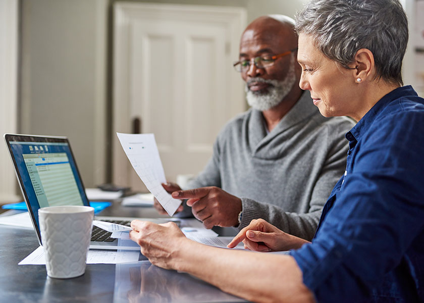 A couple doing their year-end tax planning at the kitchen table.